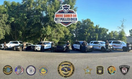 A lineup of various police vehicles with logos from different law enforcement agencies.